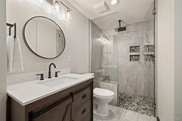 10380 W Warren Ave, Lakewood, CO 80227 - full bathroom with vanity, a stall shower, and a textured wall