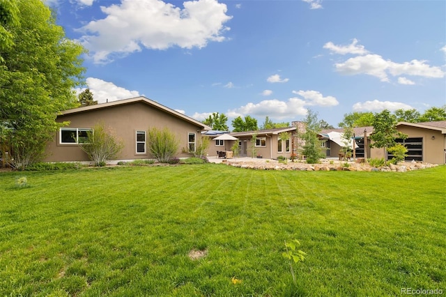 10380 W Warren Ave, Lakewood, CO 80227 - view of grassy yard featuring a patio area