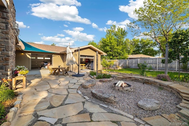 10380 W Warren Ave, Lakewood, CO 80227 - view of patio with a fire pit and an attached garage