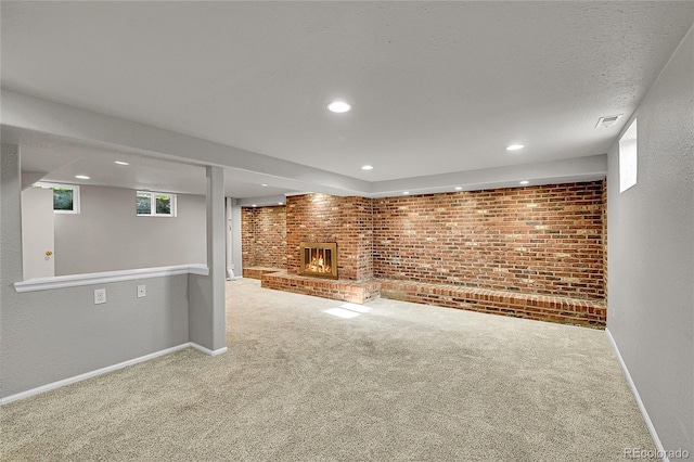 1030 Kohl St, Broomfield, CO 80020 - below grade area with carpet flooring, a brick fireplace, brick wall, and recessed lighting
