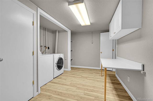 1030 Kohl St, Broomfield, CO 80020 - laundry room featuring independent washer and dryer, light wood-type flooring, cabinet space, and a textured ceiling