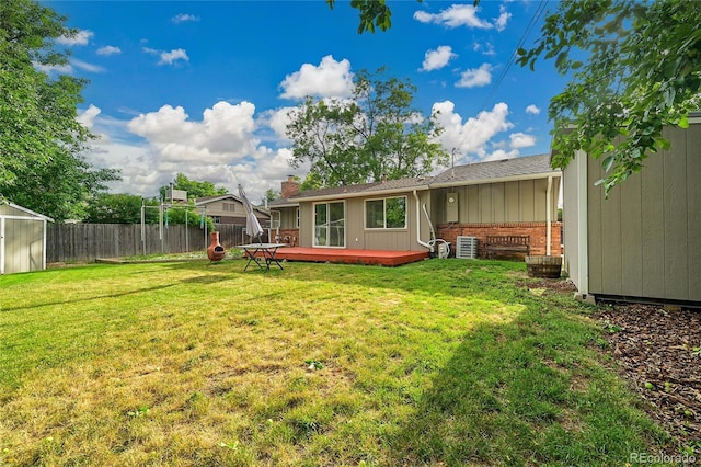1030 Kohl St, Broomfield, CO 80020 - back of house featuring a storage shed, brick siding, a wooden deck, and roof with shingles