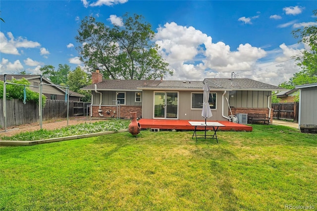 1030 Kohl St, Broomfield, CO 80020 - back of property featuring a chimney, brick siding, a fenced backyard, a deck, and board and batten siding