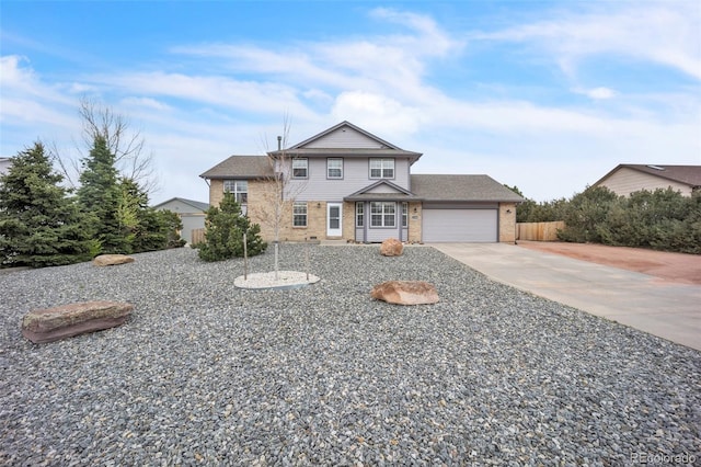 11640 Cranston Dr, Peyton, CO 80831 - view of front of home with fence, an attached garage, brick siding, and driveway