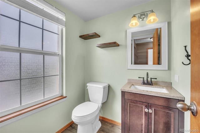 11640 Cranston Dr, Peyton, CO 80831 - bathroom with vanity, toilet, baseboards, and wood finished floors
