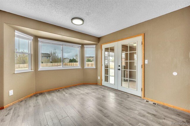 11640 Cranston Dr, Peyton, CO 80831 - spare room featuring a textured ceiling, visible vents, french doors, and baseboards