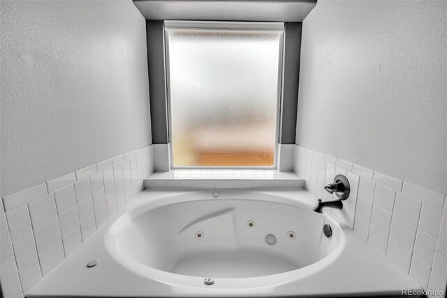 11640 Cranston Dr, Peyton, CO 80831 - bathroom featuring a jetted tub and a textured wall