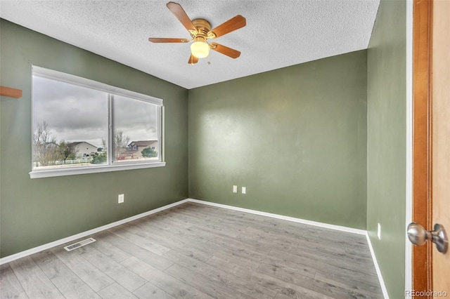 11640 Cranston Dr, Peyton, CO 80831 - unfurnished room with wood finished floors, a ceiling fan, a textured ceiling, visible vents, and baseboards