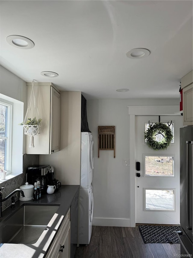47 Lumberjack Rd, Fairplay, CO 80440 - kitchen with stacked washing machine and dryer, high end refrigerator, dark countertops, a sink, and dark wood-style floors
