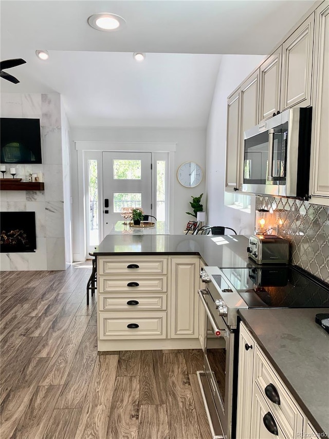 47 Lumberjack Rd, Fairplay, CO 80440 - kitchen featuring stainless steel appliances, cream cabinetry, dark countertops, open floor plan, and a peninsula