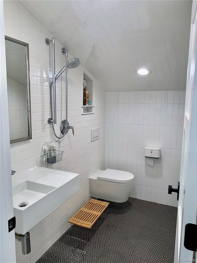 47 Lumberjack Rd, Fairplay, CO 80440 - bathroom featuring toilet, tile walls, tile patterned floors, a sink, and vaulted ceiling