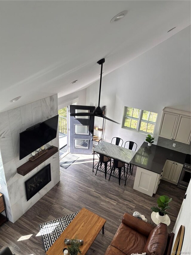 47 Lumberjack Rd, Fairplay, CO 80440 - living area with a tile fireplace, lofted ceiling, and dark wood-type flooring