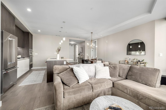 living room with a chandelier and hardwood / wood-style floors