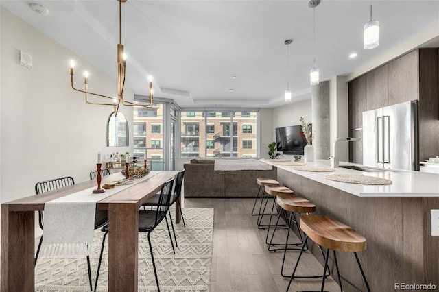 dining area featuring sink and light hardwood / wood-style flooring