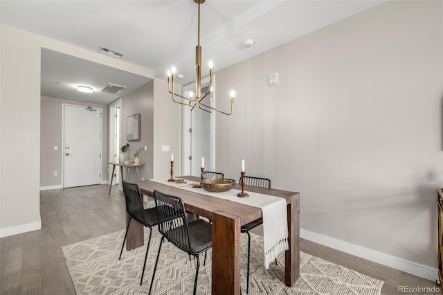 dining space with hardwood / wood-style flooring