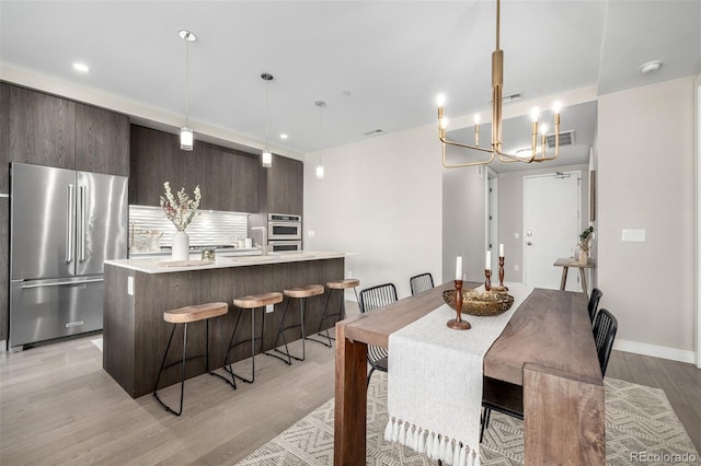 dining space featuring sink and light wood-type flooring