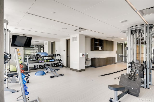 exercise room featuring light wood-type flooring