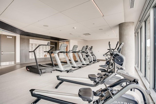 gym with a paneled ceiling