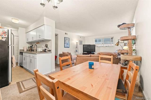 dining room featuring a textured ceiling and sink