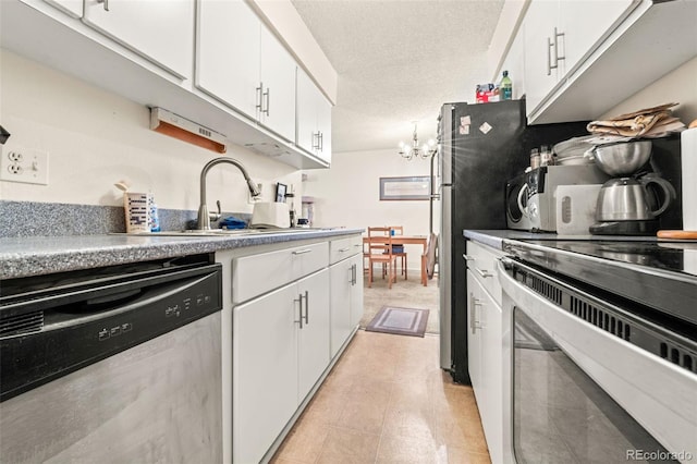 kitchen with white cabinets, a textured ceiling, and appliances with stainless steel finishes