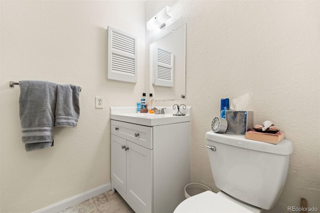 bathroom featuring toilet, vanity, and tile patterned floors