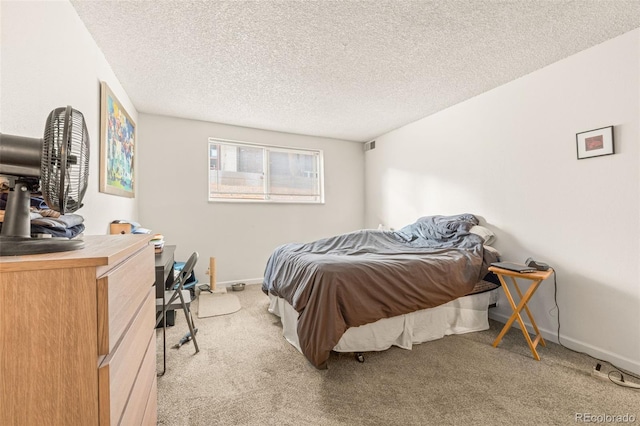 carpeted bedroom featuring a textured ceiling