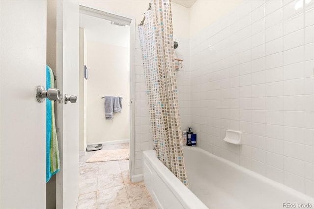 bathroom featuring tile patterned flooring and shower / bath combination with curtain