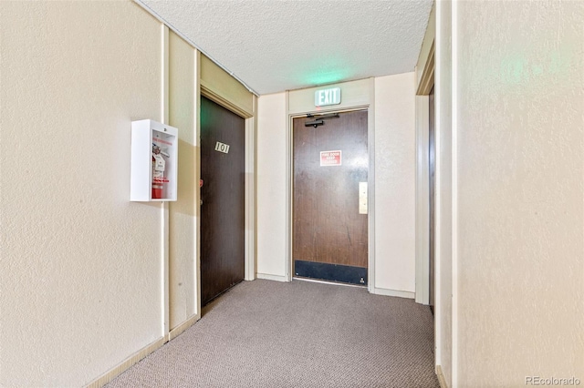 corridor featuring light carpet and a textured ceiling