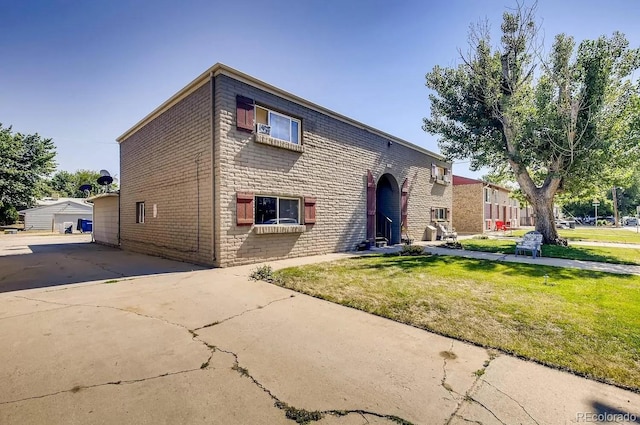 141 Mcclure Ave, Firestone, CO 80520 - view of front of house with brick siding and a front lawn