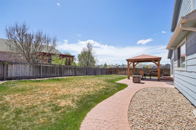 view of yard featuring a patio, a gazebo, and a fenced backyard