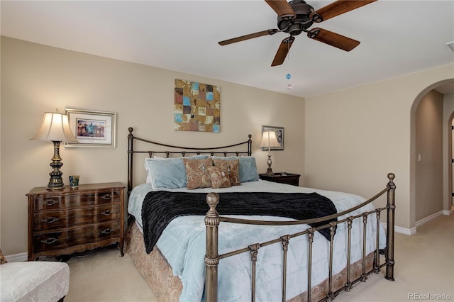 9546 Firenze Way, Highlands Ranch, CO 80126 - bedroom with arched walkways, light colored carpet, baseboards, and ceiling fan