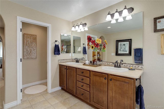 9546 Firenze Way, Highlands Ranch, CO 80126 - bathroom featuring double vanity, tile patterned floors, and baseboards