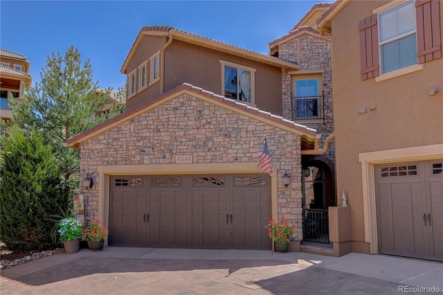 9546 Firenze Way, Highlands Ranch, CO 80126 - view of front facade featuring stone siding, stucco siding, decorative driveway, and a tile roof
