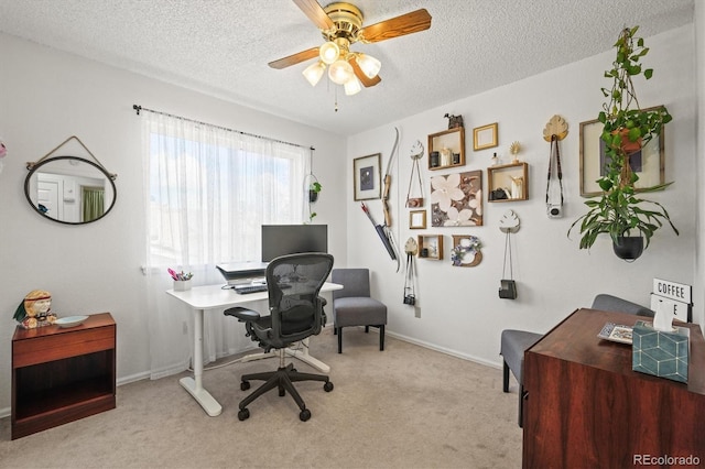 office area featuring carpet, a textured ceiling, and a ceiling fan