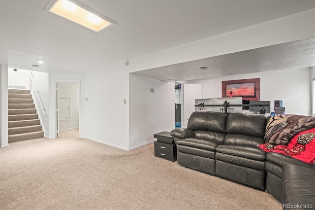 carpeted living room with baseboards, stairs, and visible vents