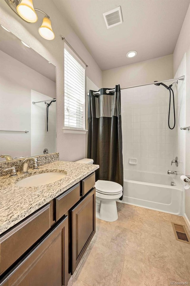 bathroom featuring toilet, vanity, shower / bath combo with shower curtain, and visible vents