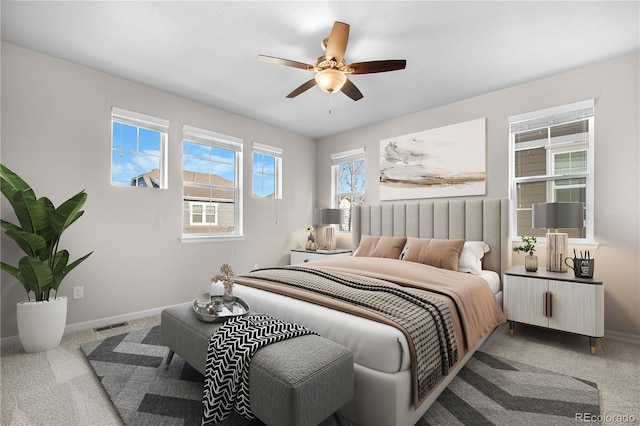 bedroom featuring ceiling fan, baseboards, visible vents, and carpet
