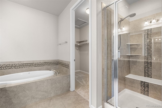 full bath with a shower stall, a walk in closet, a garden tub, and tile patterned flooring