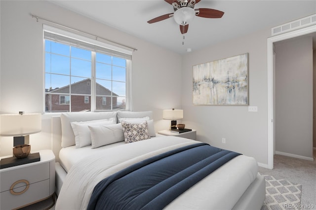 carpeted bedroom featuring visible vents, baseboards, and a ceiling fan