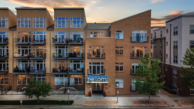 7240 W Custer Ave Unit 303, Lakewood, CO 80226 - property at dusk featuring a view of apartment building / complex