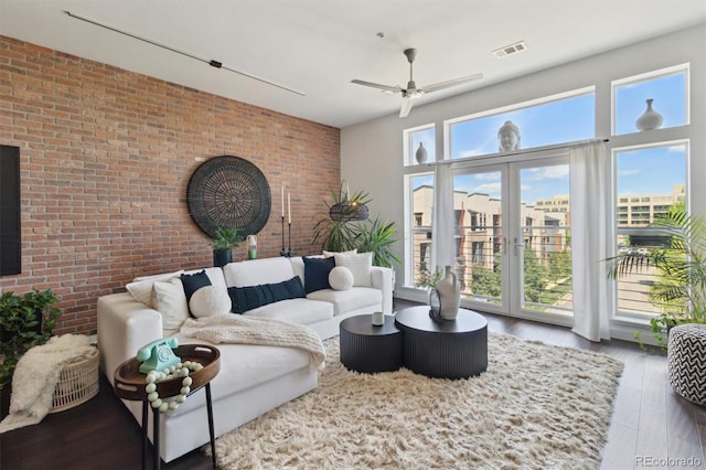 7240 W Custer Ave Unit 303, Lakewood, CO 80226 - living room featuring brick wall, ceiling fan, and wood finished floors