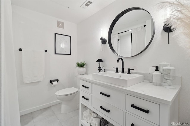 7240 W Custer Ave Unit 303, Lakewood, CO 80226 - bathroom with toilet, vanity, baseboards, and tile patterned flooring