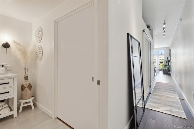 7240 W Custer Ave Unit 303, Lakewood, CO 80226 - hall featuring rail lighting, baseboards, and wood finished floors