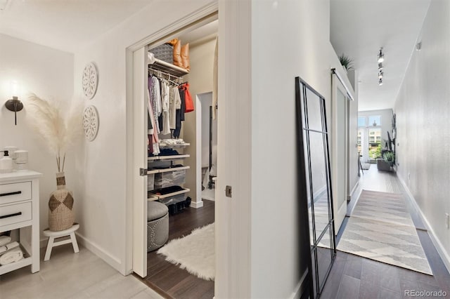 7240 W Custer Ave Unit 303, Lakewood, CO 80226 - hallway with wood finished floors, rail lighting, and baseboards