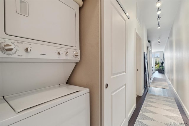 7240 W Custer Ave Unit 303, Lakewood, CO 80226 - laundry area featuring estacked washer and dryer, dark wood-type flooring, and baseboards