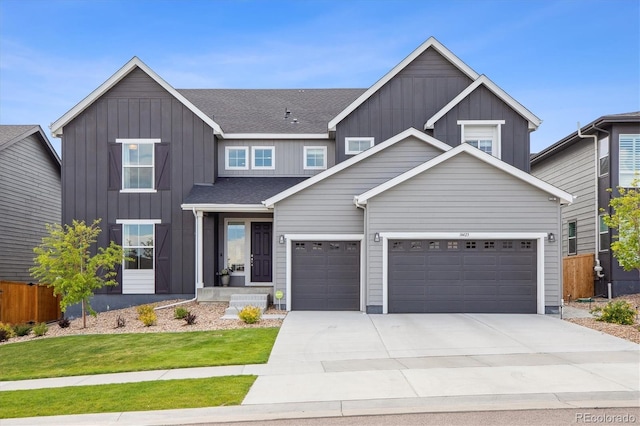 14423 Shasta Daisy Ln, Parker, CO 80134 - view of front of property featuring board and batten siding, concrete driveway, an attached garage, and roof with shingles