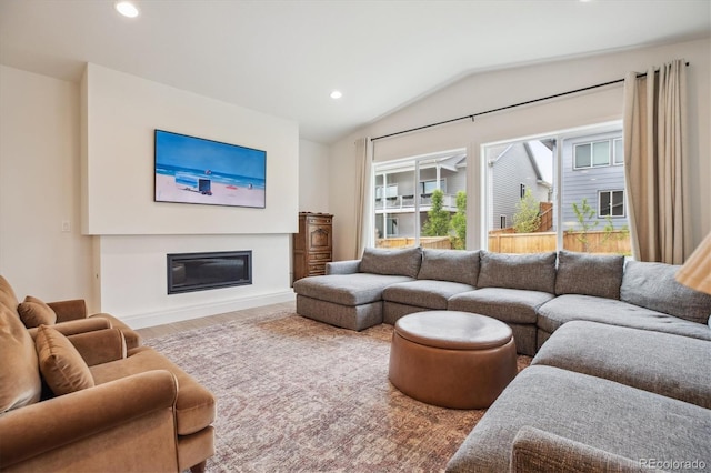 14423 Shasta Daisy Ln, Parker, CO 80134 - living room with vaulted ceiling, recessed lighting, wood finished floors, and a glass covered fireplace