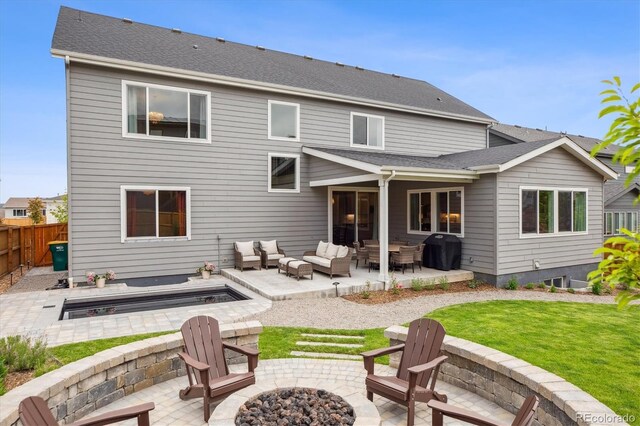 14423 Shasta Daisy Ln, Parker, CO 80134 - back of house with an outdoor living space with a fire pit, a patio area, a fenced backyard, and roof with shingles