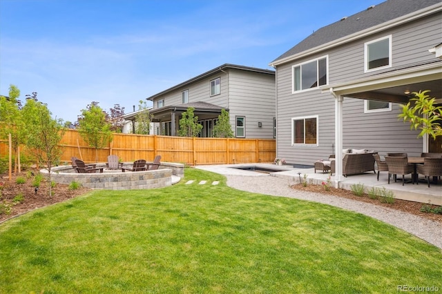 14423 Shasta Daisy Ln, Parker, CO 80134 - fenced backyard with a patio and an outdoor living space with a fire pit