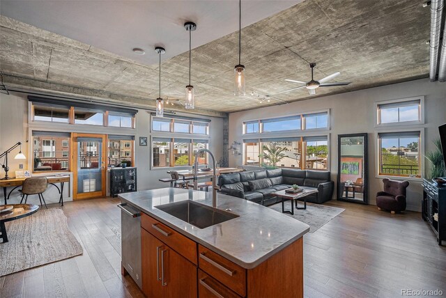 1925 W 32nd Ave Unit 404, Denver, CO 80211 - kitchen with a sink, open floor plan, brown cabinets, hardwood / wood-style flooring, and an island with sink